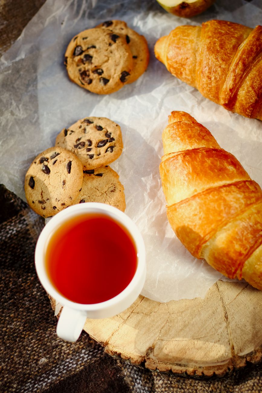 An assortment of custom bakery pastries and decorated cookies arranged on linen